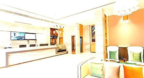 a living room with a couch and a tv at City Comfort Inn Qingyuan Longtang Light Rail Changlong in Qingyuan