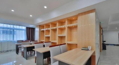 a restaurant with tables and chairs and a large window at Green Tree Inn Express Zhejiang Zhoushan Xincheng Zheda in Zhoushan