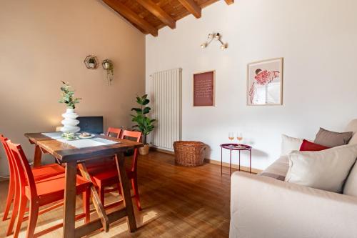 a living room with a table and chairs and a couch at Residenze Blue Lake in Omegna