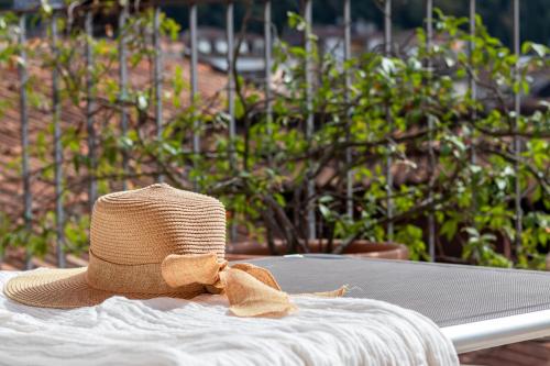 a straw hat with a bow sitting on a table at Residenze Blue Lake in Omegna