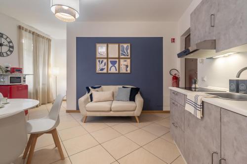 a kitchen and living room with a couch and a table at Residenze Blue Lake in Omegna