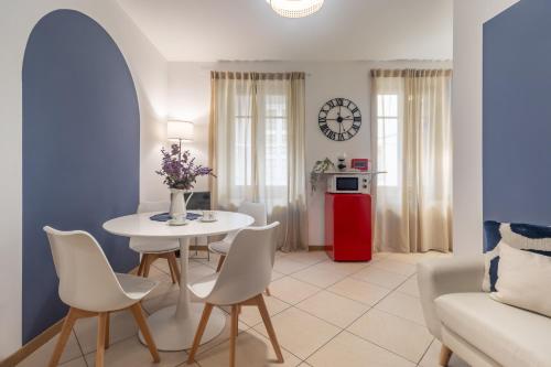 a living room with a white table and chairs at Residenze Blue Lake in Omegna