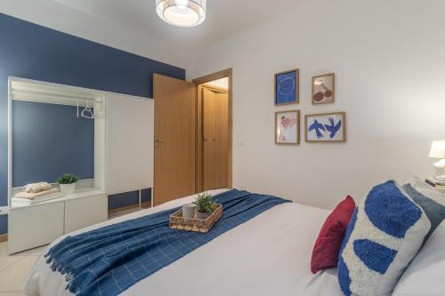 a bedroom with a bed with a blue accent wall at Residenze Blue Lake in Omegna
