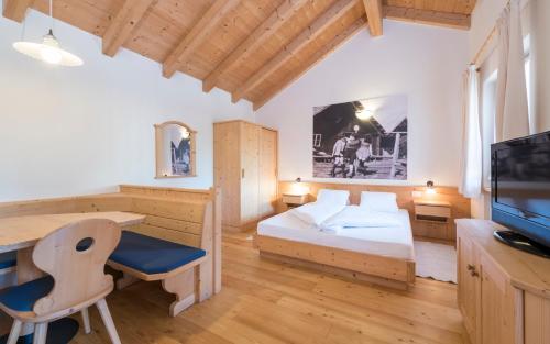 a bedroom with a bed and a desk and a computer at Apartment Lodge Gasserhof in Bressanone