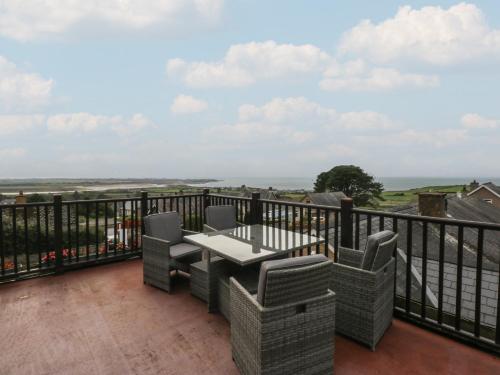 a patio with a table and chairs on a balcony at Maesawel Studio in Harlech