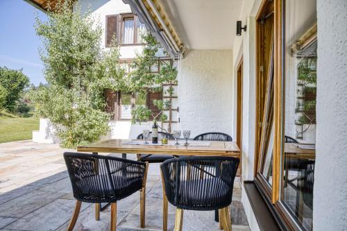 a kitchen with a table and chairs on a patio at Gästehaus Alpina in Krün