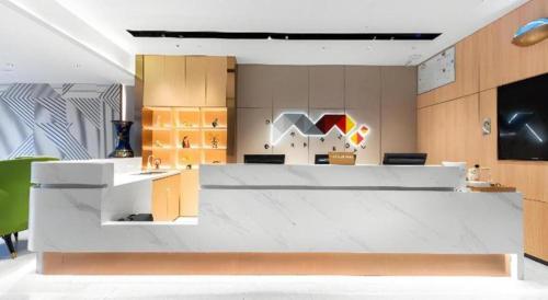 an office with a large white counter and a desk at Borrman Hotel Wuhan Hankou Railway Station Metro Station in Wuhan