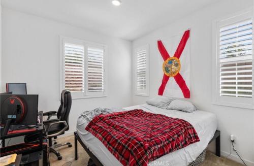 a bedroom with a bed with a red ribbon on the wall at Rois Yucaipa in Yucaipa