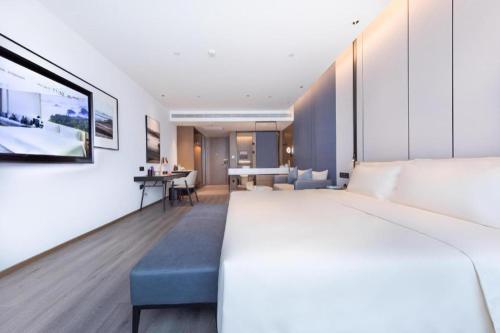 a hotel room with a bed and a desk at Atour Hotel Jinan Tangyan Century Avenue in Jinan