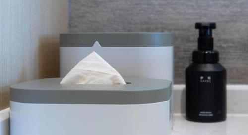 a soap dispenser and a bottle on a counter at Atour Hotel Jinan Tangyan Century Avenue in Jinan