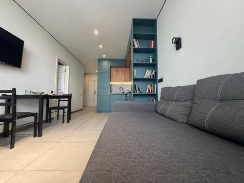 a living room with a couch and a dining room at Видові Апартаменти Residential GREAT ліфт, вода, тепло WiFi Працюють без світла in Kyiv
