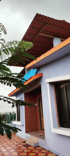 a small house with a red and white at Harekar Villa in Jalgaon