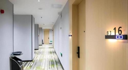 a hallway of an empty room with a long hallway at GreenTree Inn Express Fuyang University Town West High-Speed Railway Station in Fuyang