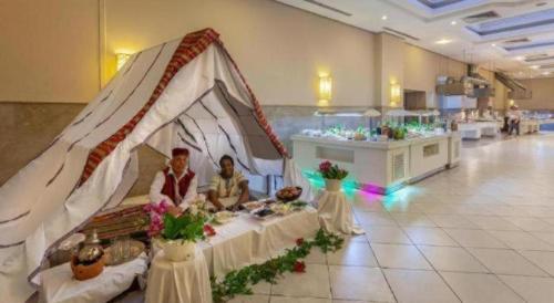 two people sitting in a tent in a room at Djerba Holiday Beach in Midoun