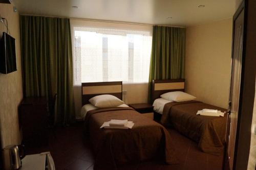 Postel nebo postele na pokoji v ubytování Hotel Viktoriya