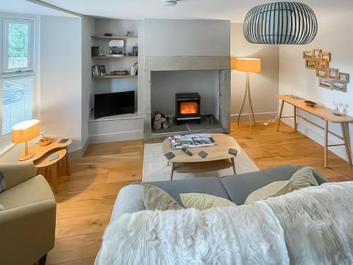 a living room with a couch and a fireplace at Walkers Retreat in Crook