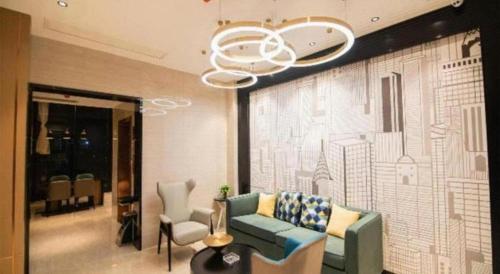 a living room with a couch and a chandelier at City Comfort Inn Changsha Sifangping University of National Defense Science and Technology in Changsha