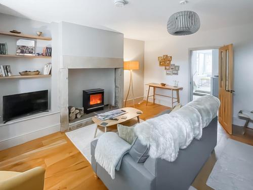 a living room with a couch and a fireplace at Walkers Retreat in Crook