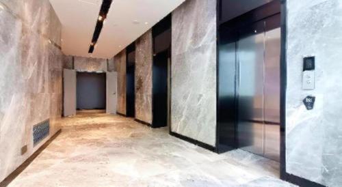 an empty hallway with a elevator in a building at Echarm Hotel Wuhan Gaotie Jianshe 2nd Road Metro Exit in Wuhan