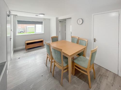 a dining room with a table and chairs at Riverside Cottage in Pinchbeck