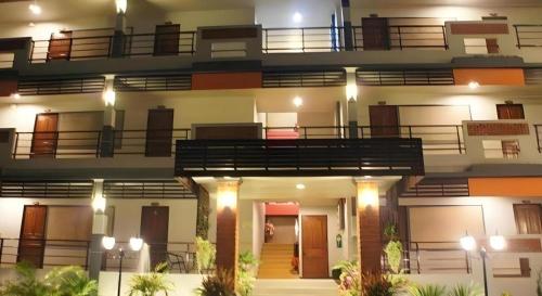 a building with balconies on top of it at Nan Treasure Hotel in Nan