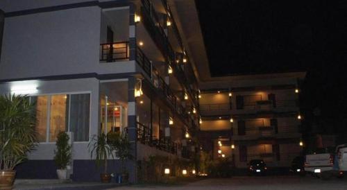 a building with lights on the side of it at night at Nan Treasure Hotel in Nan