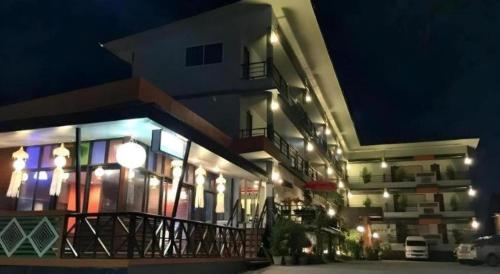 a large building with lights on it at night at Nan Treasure Hotel in Nan