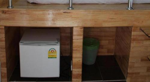 a small refrigerator under a table with a counter top at The Grace Residence in Surin