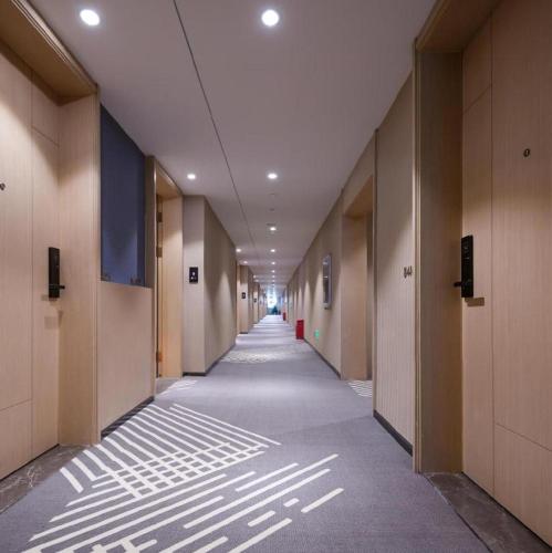 an empty hallway of an office building with a long corridor at ZMAX Hotels Shenzhen Lianhuacun Metro Station in Shenzhen