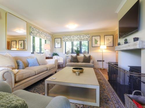 a living room with couches and a fireplace at Brookside in Highway