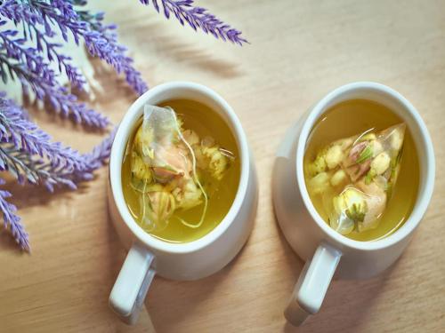 two cups of soup sitting on a wooden table at Lavande Hotel Changchun Gaoxin Jilin University in Changchun