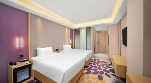 a hotel room with two beds and a television at Lavande Hotel Changchun Gaoxin Jilin University in Changchun