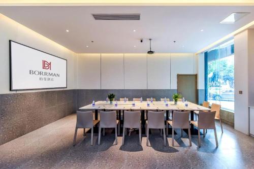 a conference room with a large table and chairs at Borrman Hotel Chongqing Bishan Central Street in Chongqing
