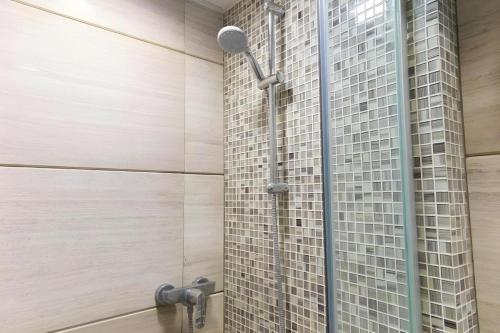 a shower in a bathroom with a glass wall at Metroplace Boutique in Hong Kong
