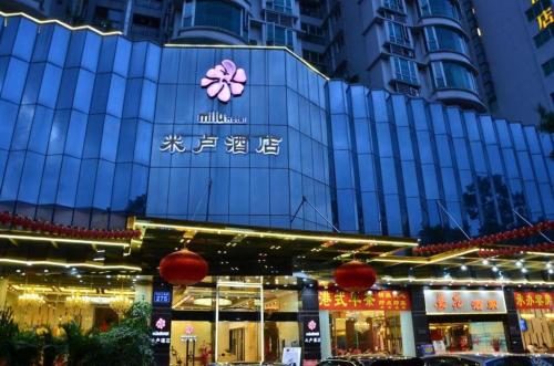 a building with a sign on the side of it at Milu Hotel in Guangzhou