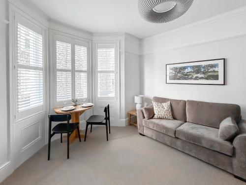 a living room with a couch and a table at Pebble Hideaway - Uk50551 in Worthing