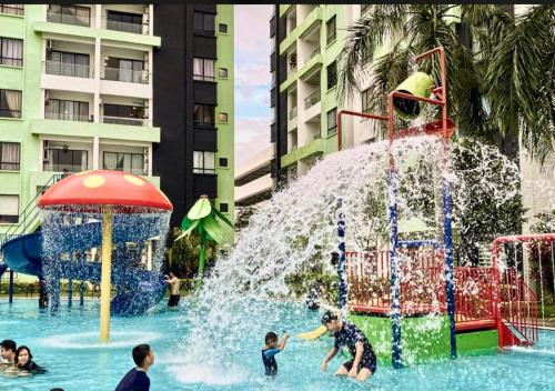 a group of children playing in a water park at Ipoh Waterpark Manhattan Premium Suites by IWH Suites in Ipoh