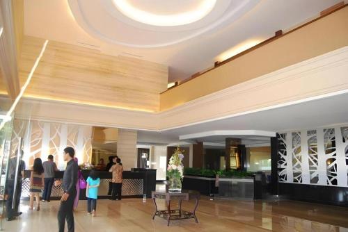a group of people standing in a lobby at The Axana Hotel in Padang