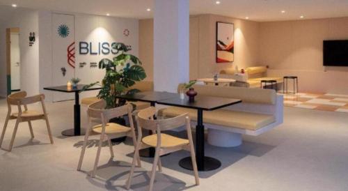 a living room with a table and chairs and a couch at 777Bliss Hometel in Nakhon Phanom
