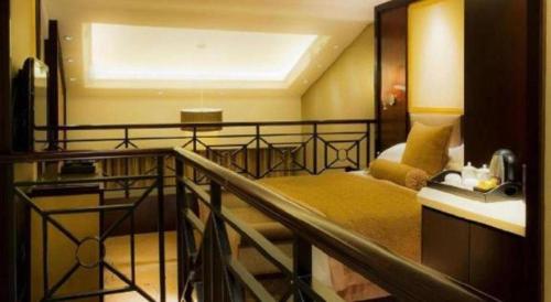 a bedroom with a balcony with a bed and a balcony at Royal Tulip Hotel Zhujiajiao Shanghai in Shanghai