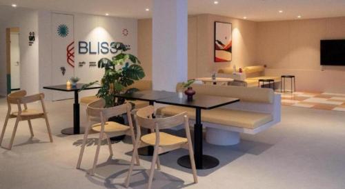 a living room with a table and chairs and a couch at 777Bliss Hometel in Nakhon Phanom