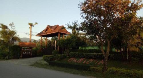 a house with a gazebo on the side of a street at Indie House @ Maerim in Chiang Mai