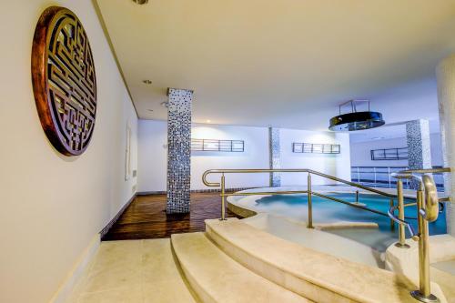 a pool in a building with stairs and a sign on the wall at SBH Costa Calma Palace Thalasso & Spa in Costa Calma