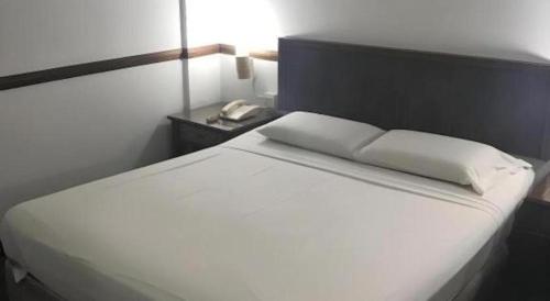 Ένα ή περισσότερα κρεβάτια σε δωμάτιο στο Four Chain View Hotel