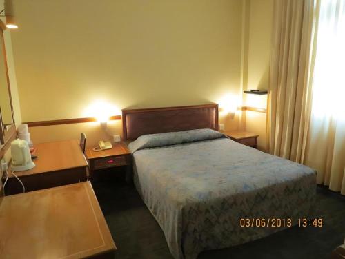 Ένα ή περισσότερα κρεβάτια σε δωμάτιο στο Four Chain View Hotel