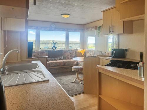 a kitchen and a living room with a couch at Emerald Pines - Uk50577 in Blanchland