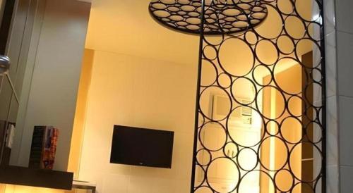 a living room with a tv and a mirror at One Serenata Hotel General Trias in Silang