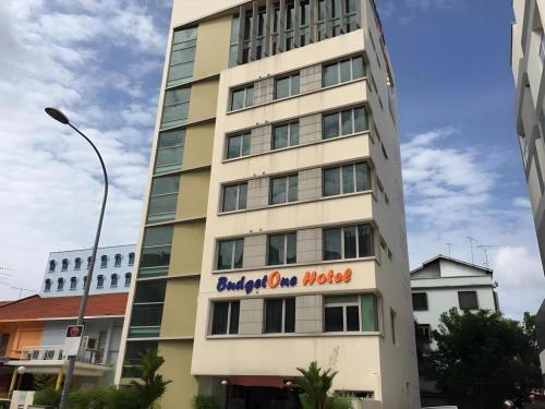 a tall building with a sign on the side of it at BudgetOne Hotel in Singapore