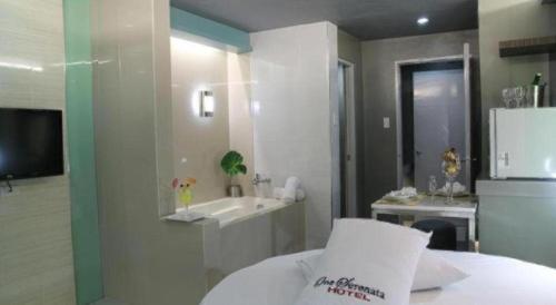 a bathroom with a bed and a sink at One Serenata Hotel General Trias in Silang