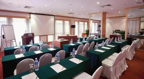 a conference room with green tables and white chairs at Hotel Miramar Singapore in Singapore